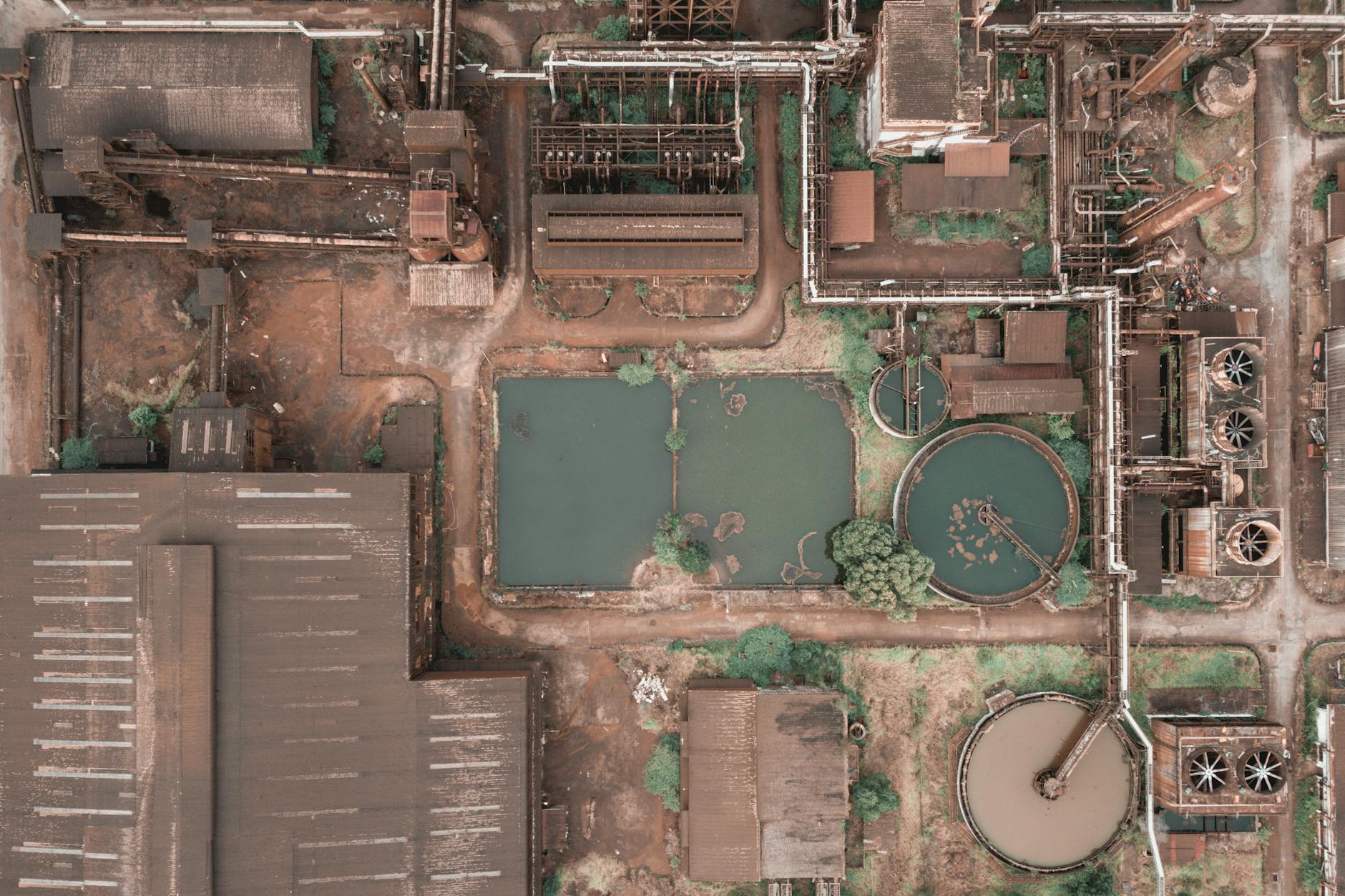 Aerial shot of an industrial facility in Malaysia with visible ponds and machinery.