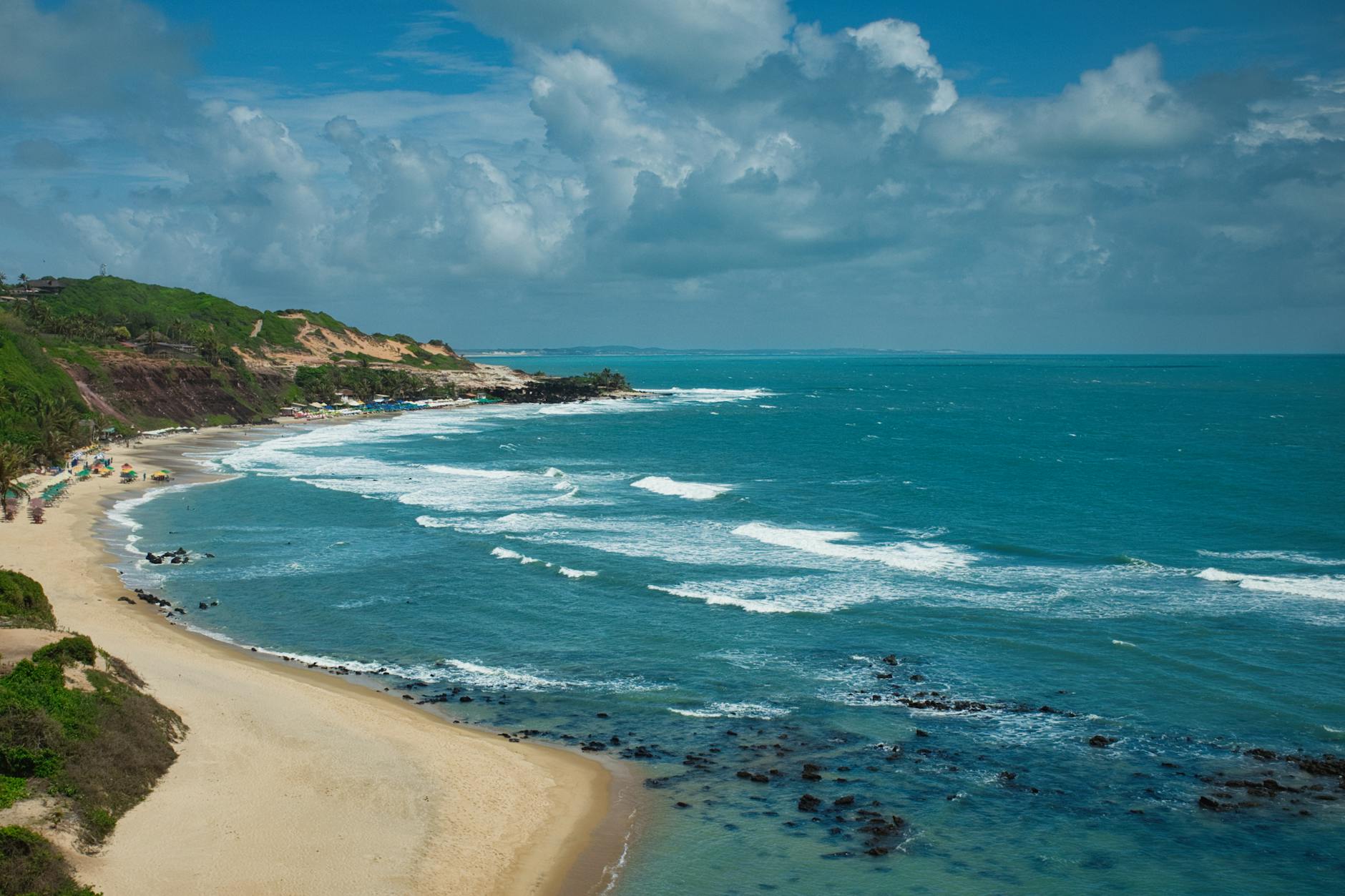Beautiful aerial view of Pipa Beach with turquoise waves along the Brazilian coast.