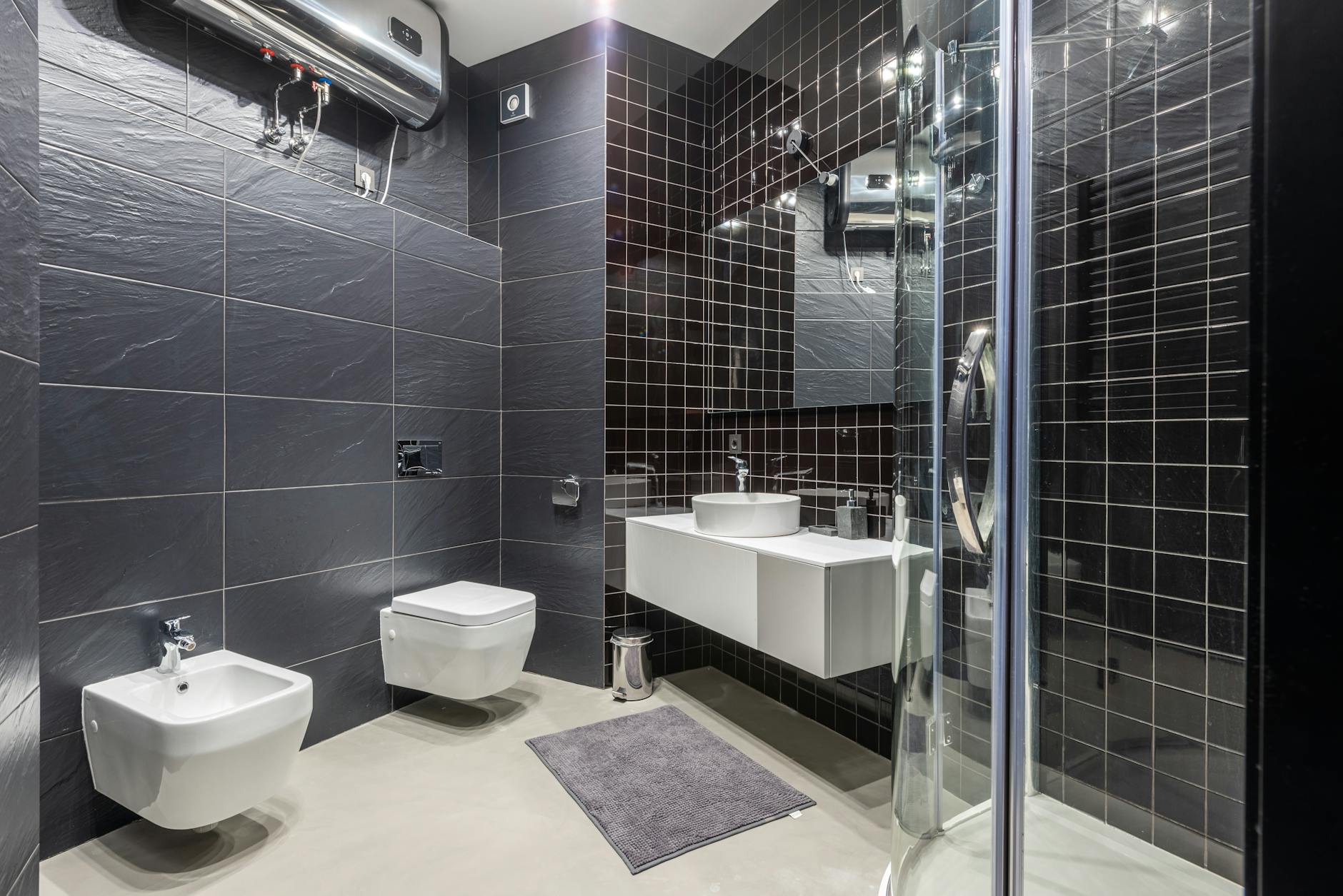 Interior design of modern bathroom with shower and bidet decorated with black tile