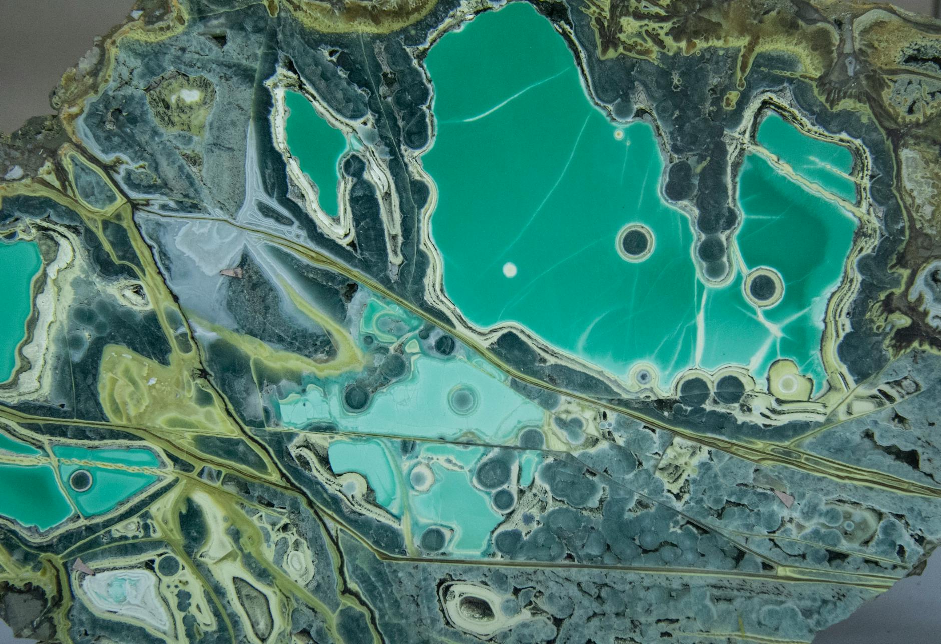 A captivating abstract image featuring aqua blue and green patterns resembling aerial landscapes.