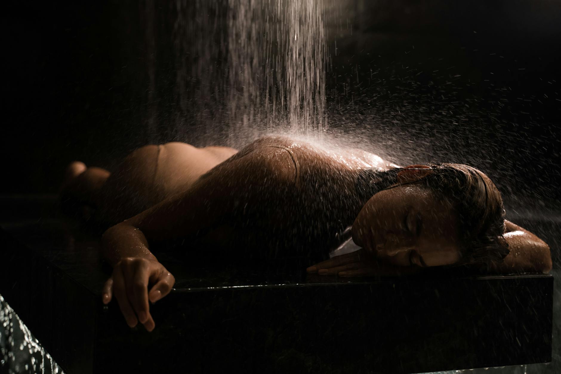 A serene image of a woman receiving a spa water massage, highlighting relaxation and luxury.